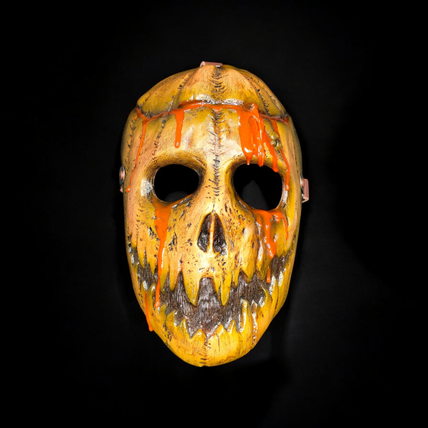 A sinister pumpkin mask with orange ooze.