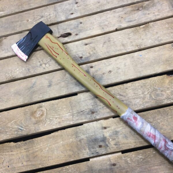 A PU foam replica axe with a blood covered bandage wrapped around the handle.