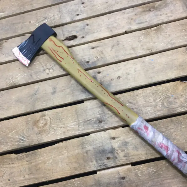 A PU foam replica axe with a blood covered bandage wrapped around the handle.