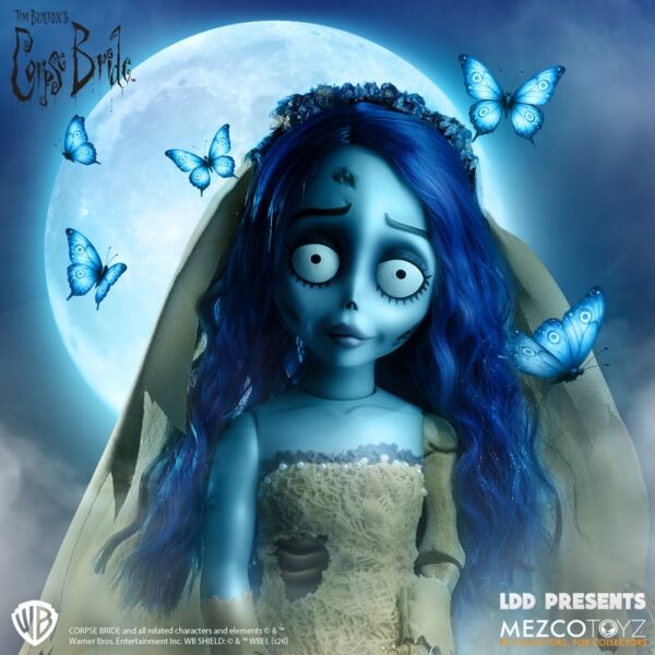 “With this hand, I will lift your sorrows. Your cup will never empty, for I will be your wine.” The hauntingly beautiful Corpse Bride: Emily joins Mezco's Living Dead Dolls Presents collection. Inspired by Tim Burton's beloved animated film, Emily is dressed in her iconic tattered wedding gown, complete with a flowing veil and delicate floral details. Capturing her unforgettable appearance, this collectible features blue skin, flowing blue hair, and a wistful expression that brings the tragic bride to life. Standing 10 inches tall with 5 points of articulation, Emily comes packaged in a display-friendly die-cut window box, making her a perfect addition to any Corpse Bride or Living Dead Dolls collection.