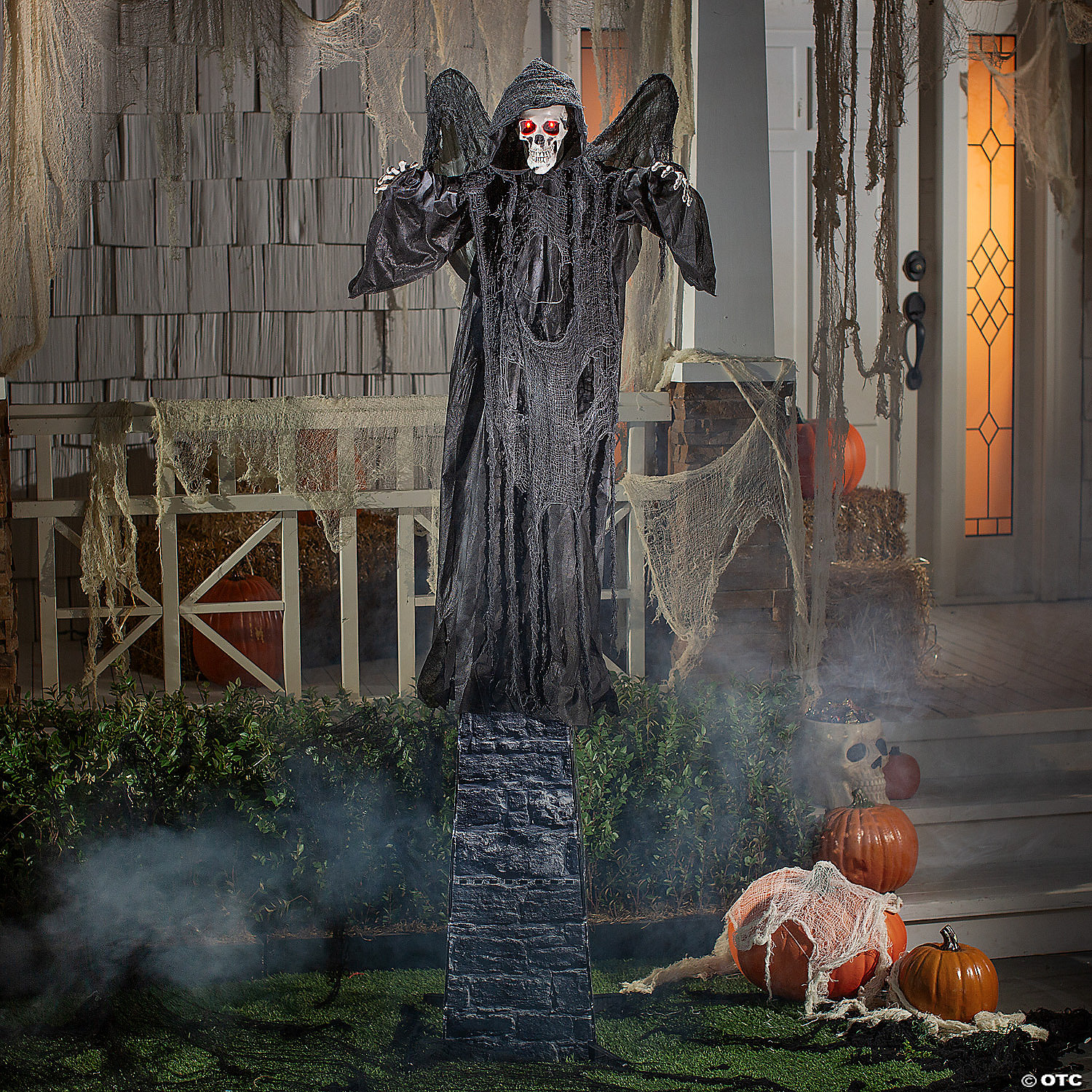 Six-foot Standing Skeletal Reaper animatronic on a porch surrounded by cobwebs, pumpkins and low fog