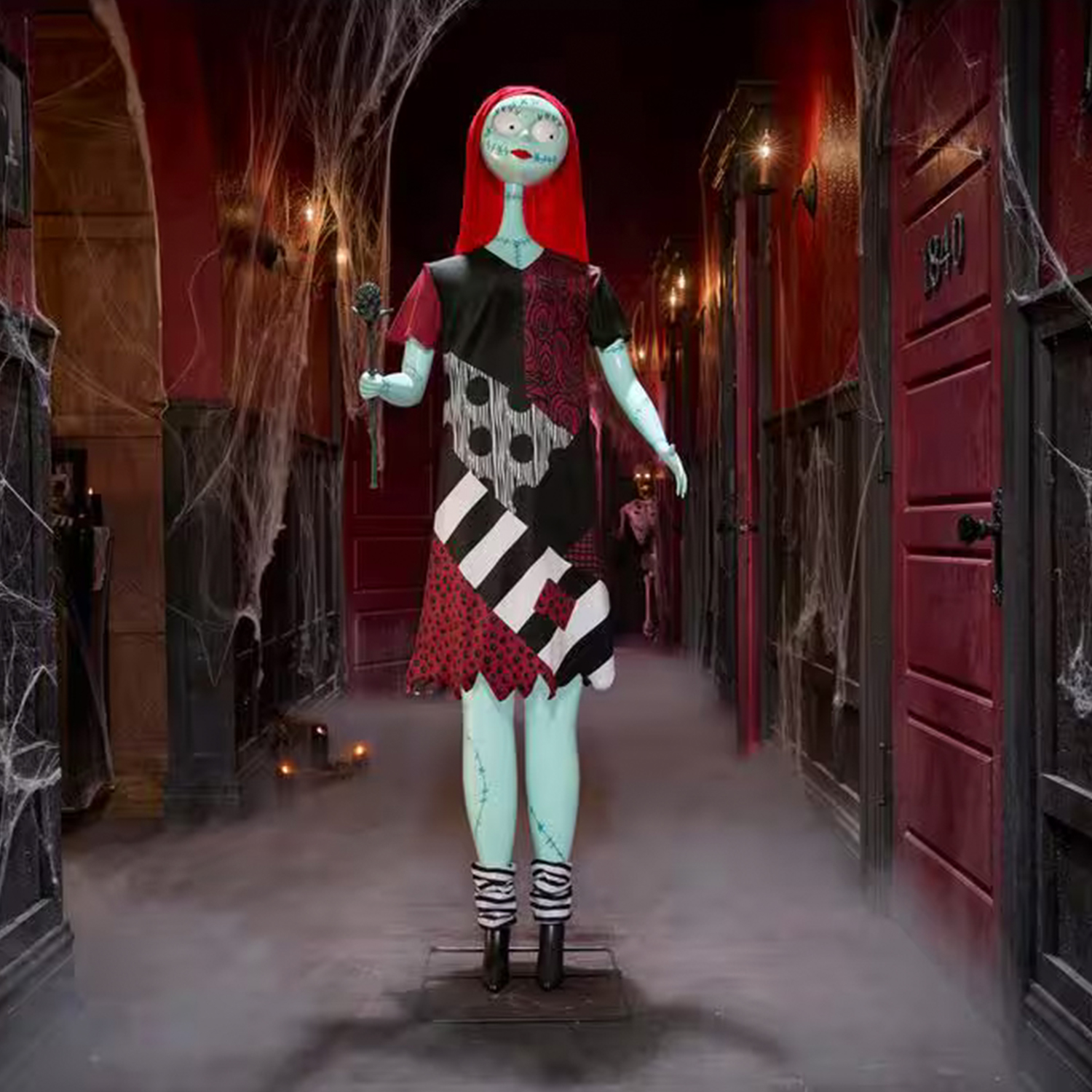 Life-size Sally animatronic from The Nightmare Before Christmas standing at the end of a dressed hallway