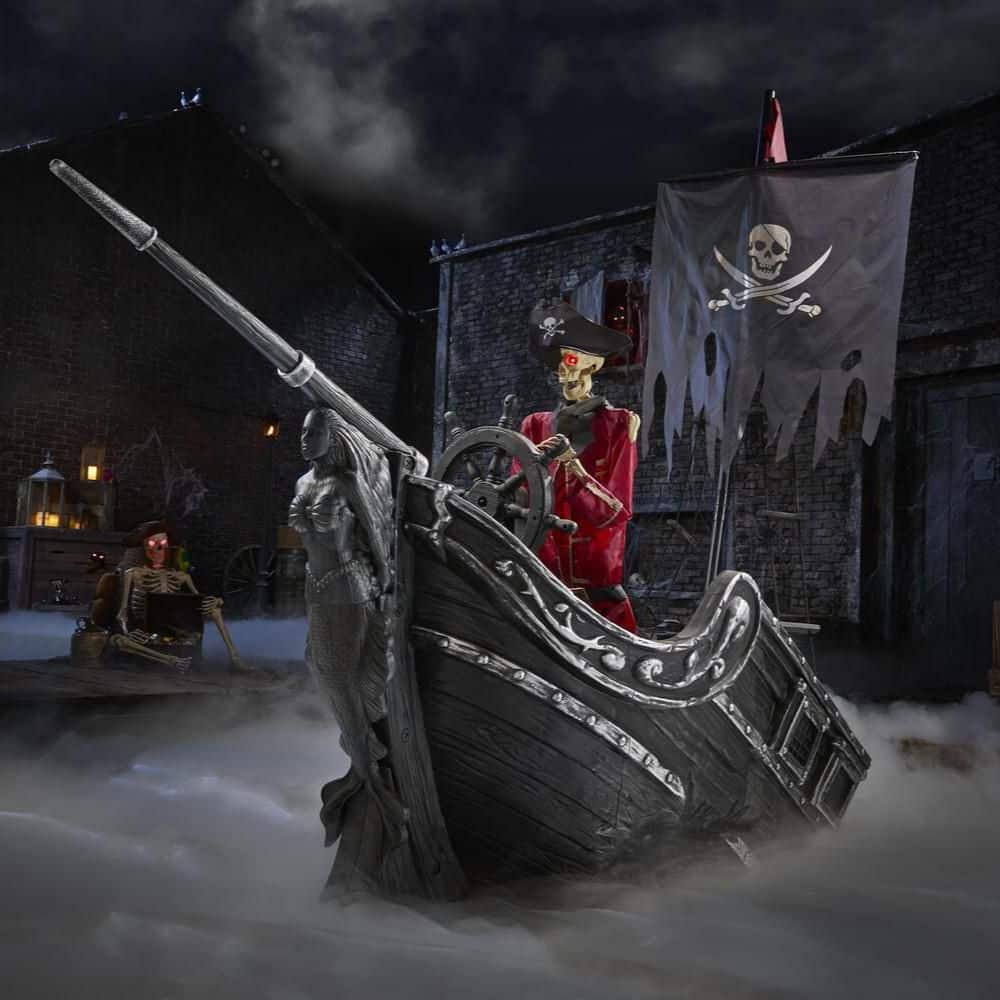 Dead Water pirate ship prop with a skeleton captain at the helm, rising from fog in a lit display