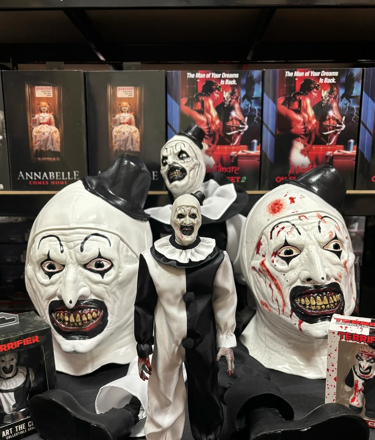 Art the Clown latex masks displayed side by side, clean-faced and blood-spattered versions